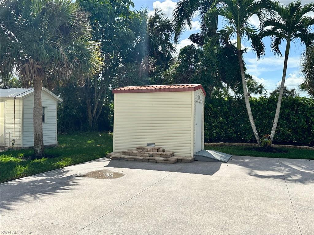 1275 Silver Lakes Boulevard Naples, FL 34114 - Photo 5 of 11 View of patio with a shed