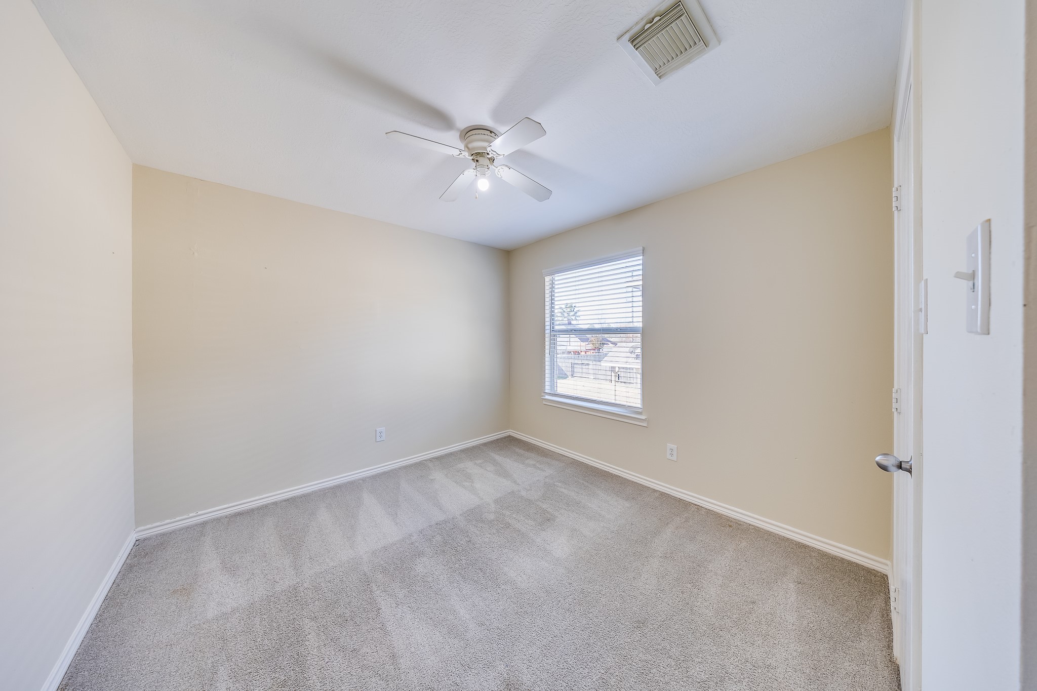 20003 Rustic Lake Lane Cypress, TX 77433 - Photo 14 of 21 an empty room with windows and fan