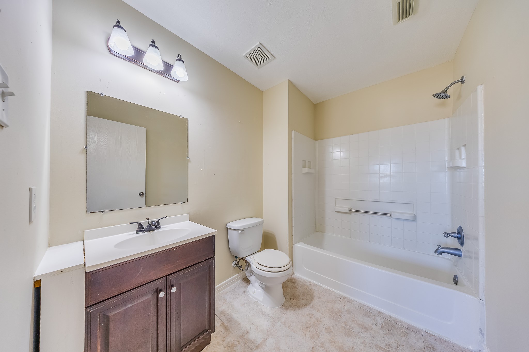 20003 Rustic Lake Lane Cypress, TX 77433 - Photo 16 of 21 a bathroom with a bathtub shower sink mirror vanity and toilet