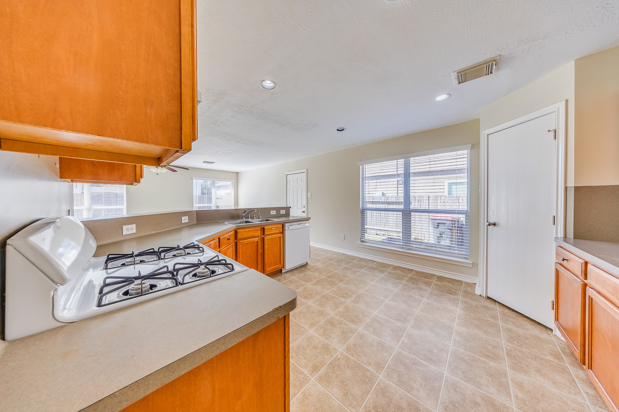 20003 Rustic Lake Lane Cypress, TX 77433 - Photo 6 of 21 a kitchen with stainless steel appliances granite countertop a stove a sink and a microwave