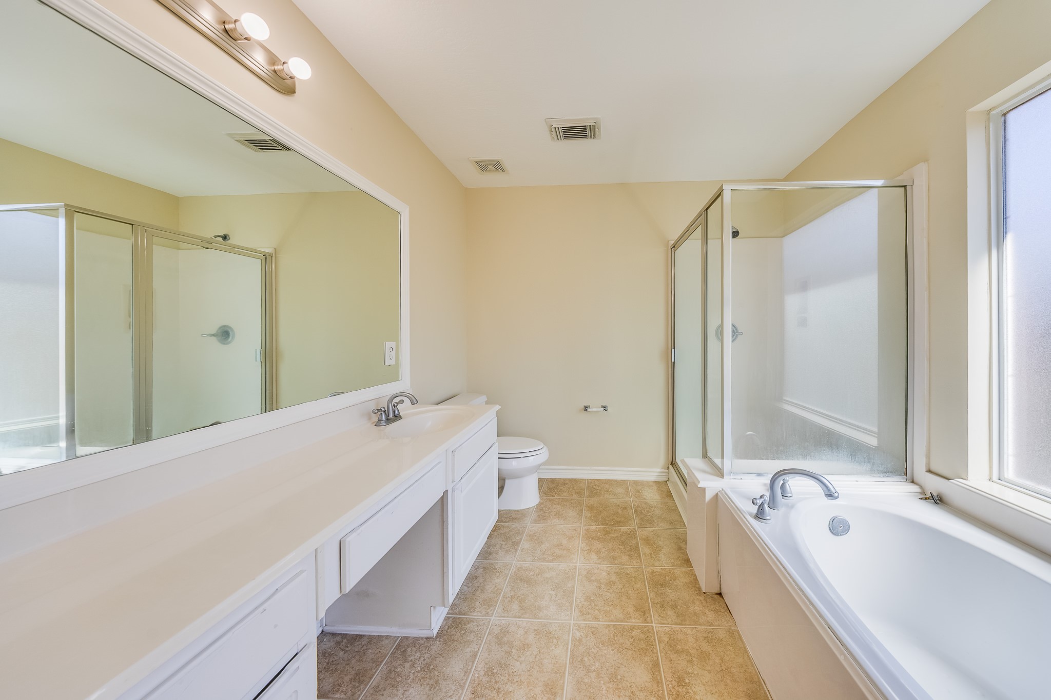 20003 Rustic Lake Lane Cypress, TX 77433 - Photo 9 of 21 a spacious bathroom with a tub sink and mirror