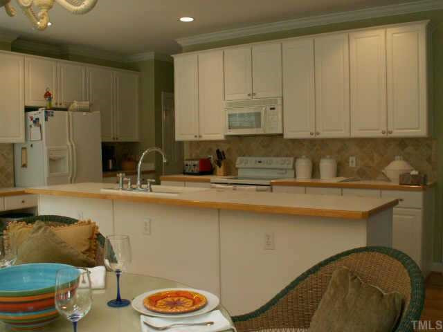 7705 Wilderness Road Raleigh, NC 27613 - Photo 7 of 10 View of kitchen with center island and beautiful, sunny breakfast room. Other