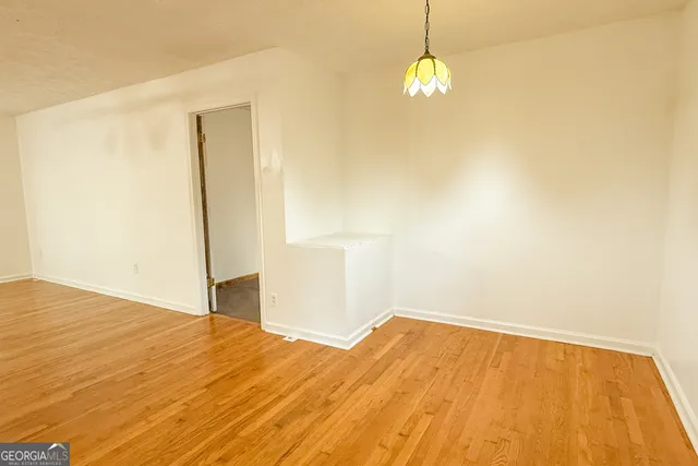 an empty room with a ceiling fan and a window