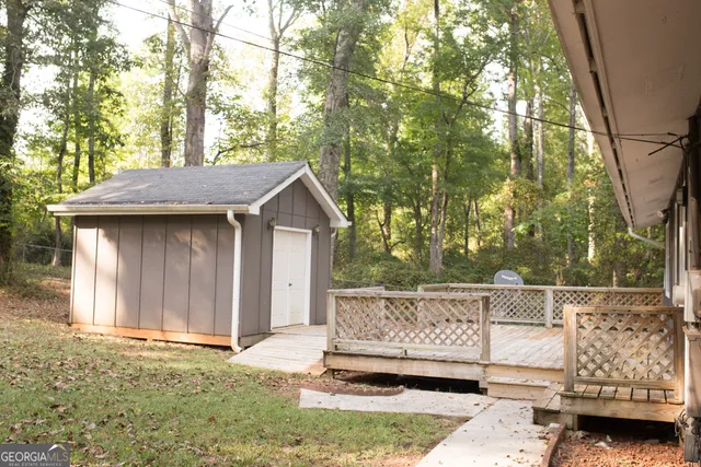 a view of a wooden fence and trees in the background