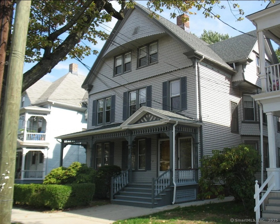319 Sherman Avenue New Haven, CT 06511 - Photo 1 of 19 a view of a white house with large windows and a small yard