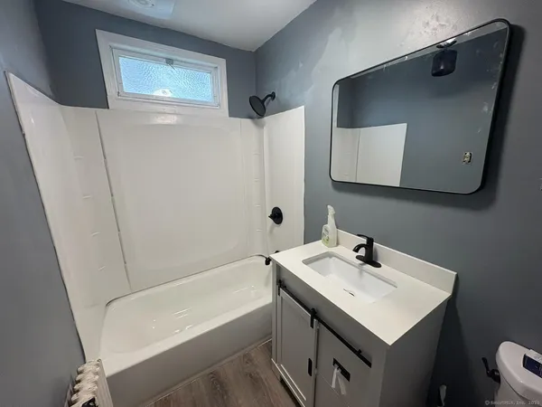 a bathroom with a sink a mirror and a toilet