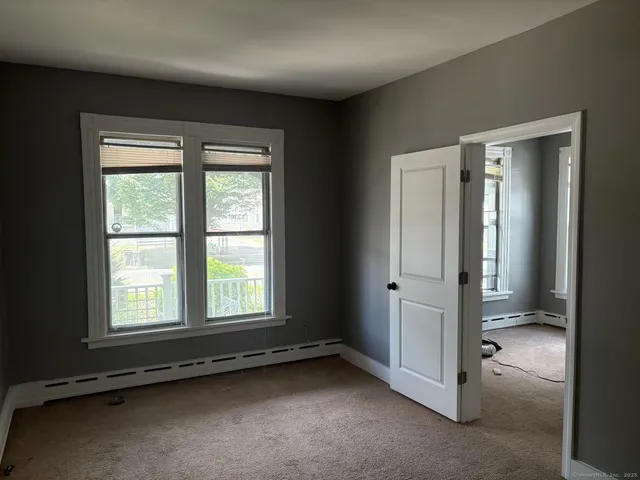 an empty room with a empty space and windows