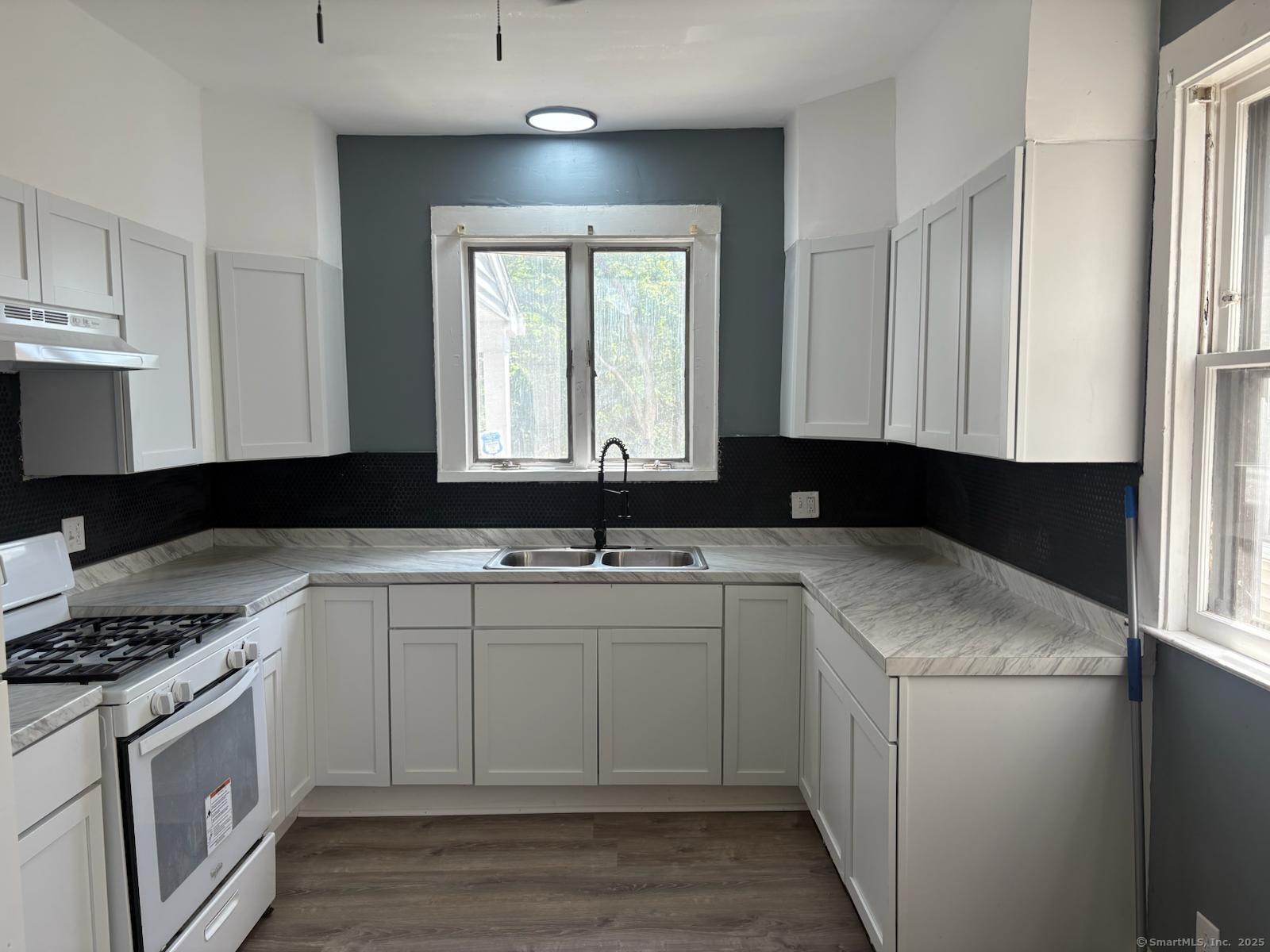 319 Sherman Avenue New Haven, CT 06511 - Photo 6 of 19 a kitchen with a sink and a stove top oven