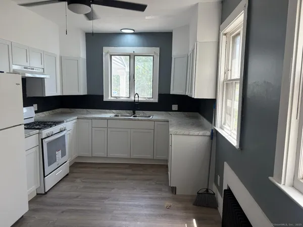 a kitchen with a sink stove and cabinets