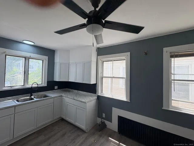 a kitchen that has a sink and a stove in it