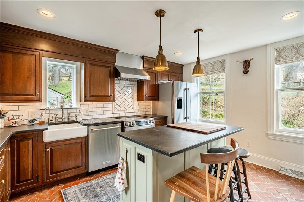 701 Oakbourne Road West Chester, PA 19382 - Photo 17 of 50 a kitchen with a sink stove and wooden floor