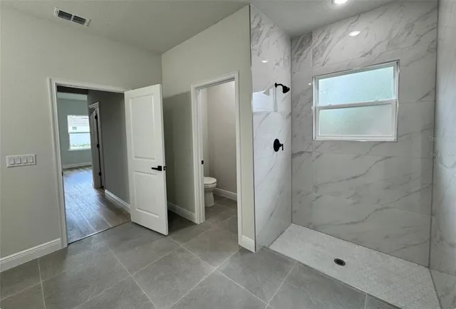 a view of an empty room and wooden floor