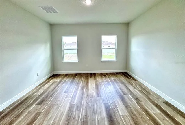 a view of closet with wooden floor