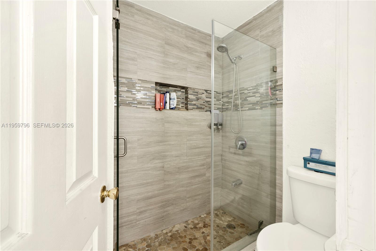 14600 Southwest 124th Place Miami, FL 33186 - Photo 14 of 34 a bathroom with a shower and toilet