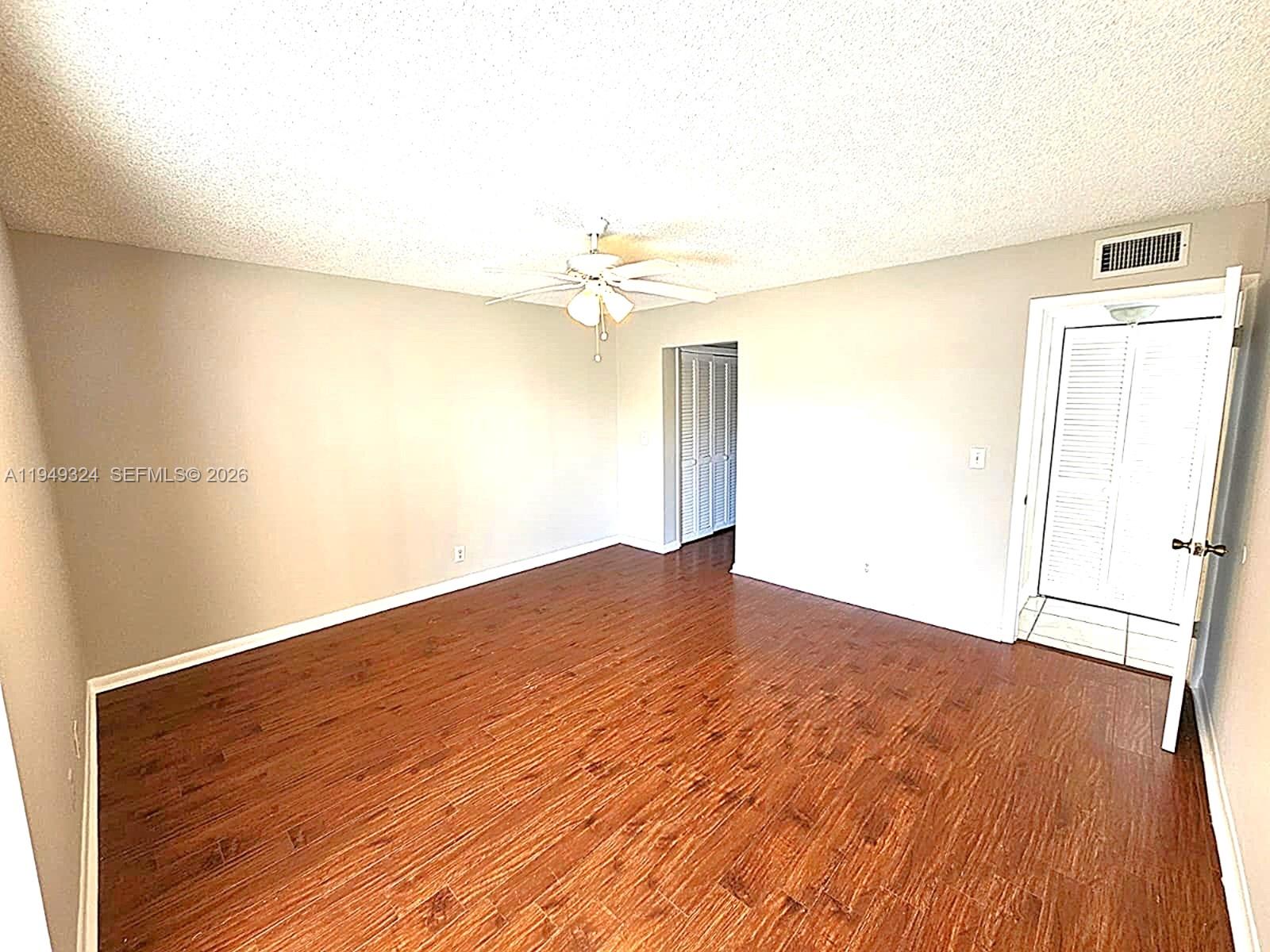 642 Northwest 13th Street, Unit 310 Boca Raton, FL 33486 - Photo 12 of 32 a view of empty room with wooden floor