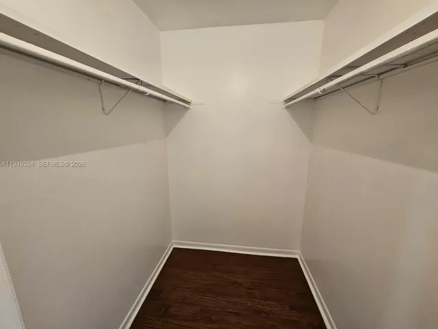 a bathroom with a granite countertop sink a mirror and shower