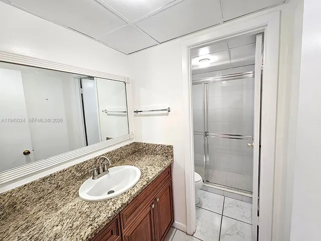a bathroom with a shower and a toilet