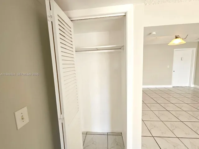 a kitchen with kitchen island granite countertop wooden cabinets a sink and dishwasher