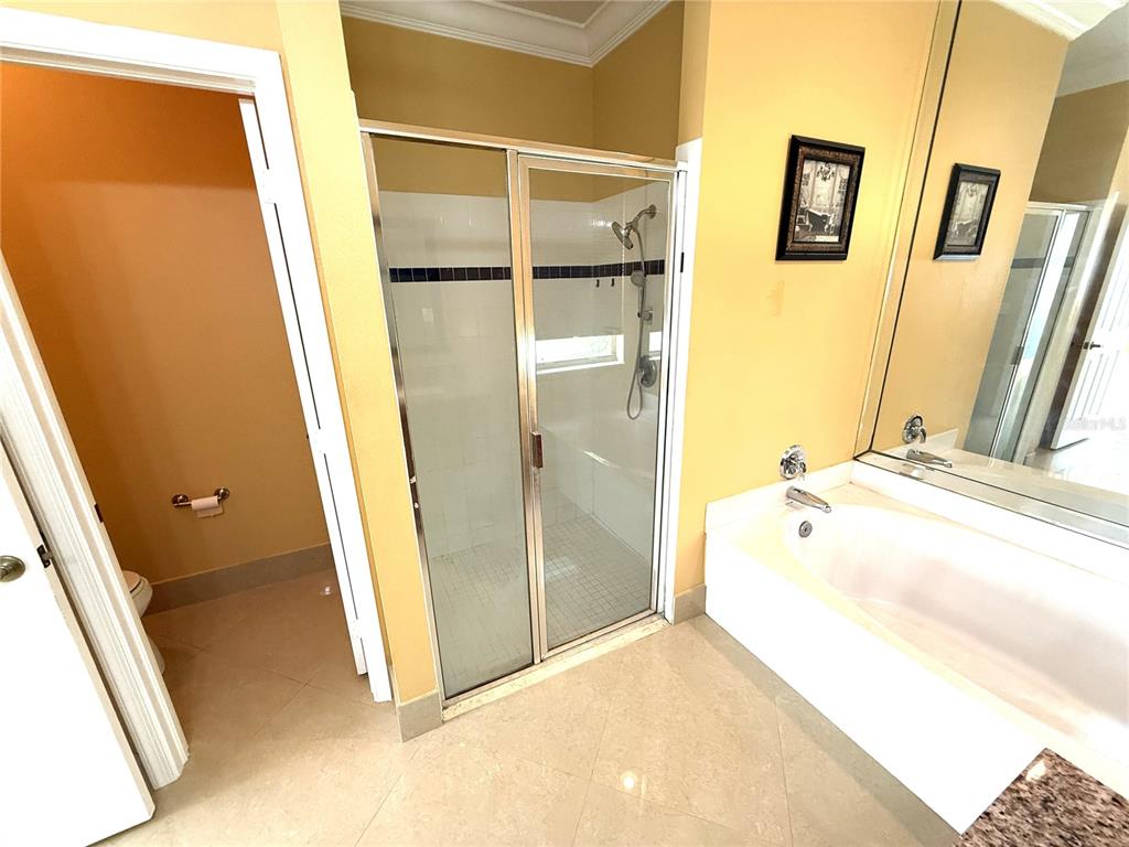 3865 Northwest Deer Oak Drive Jensen Beach, FL 34957 - Photo 17 of 34 a bathroom with a tub and shower