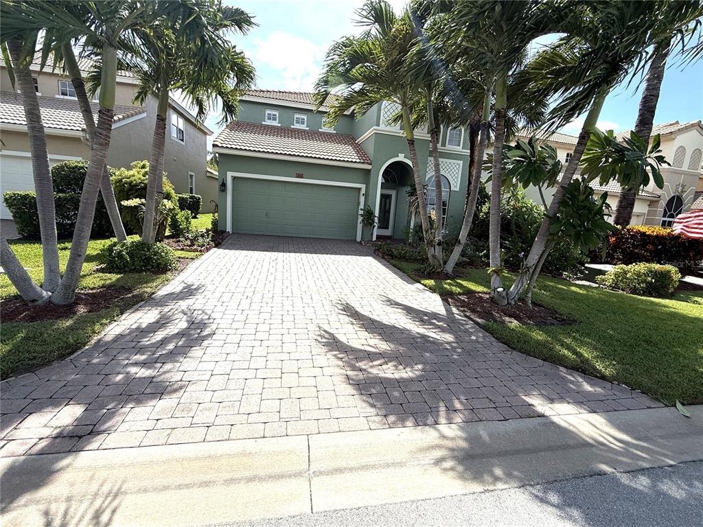 3865 Northwest Deer Oak Drive Jensen Beach, FL 34957 - Photo 2 of 34 a front view of a house with a garden