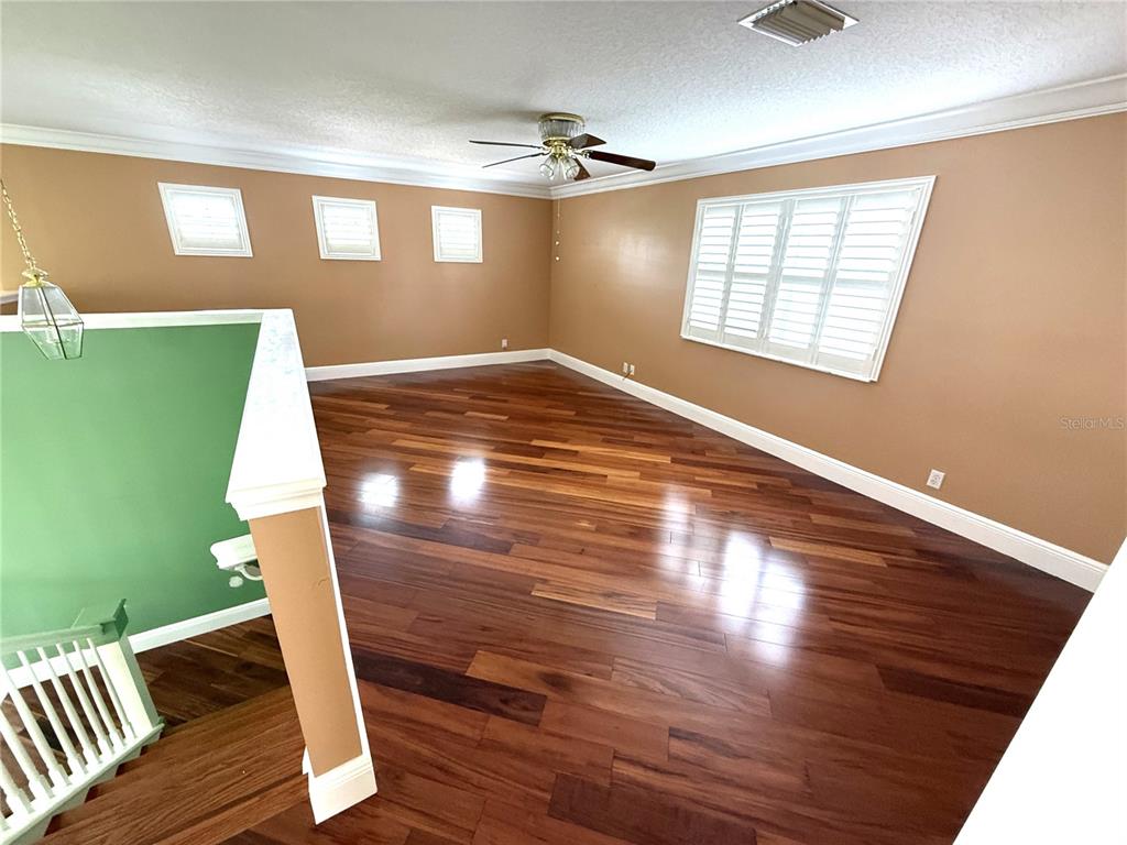3865 Northwest Deer Oak Drive Jensen Beach, FL 34957 - Photo 25 of 34 a view of an empty room with wooden floor and a window