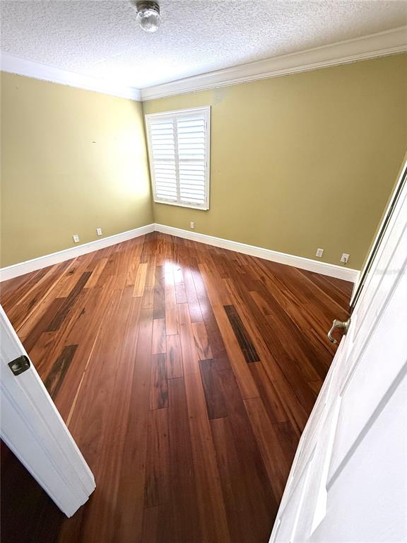 3865 Northwest Deer Oak Drive Jensen Beach, FL 34957 - Photo 26 of 34 an empty room with wooden floor and windows