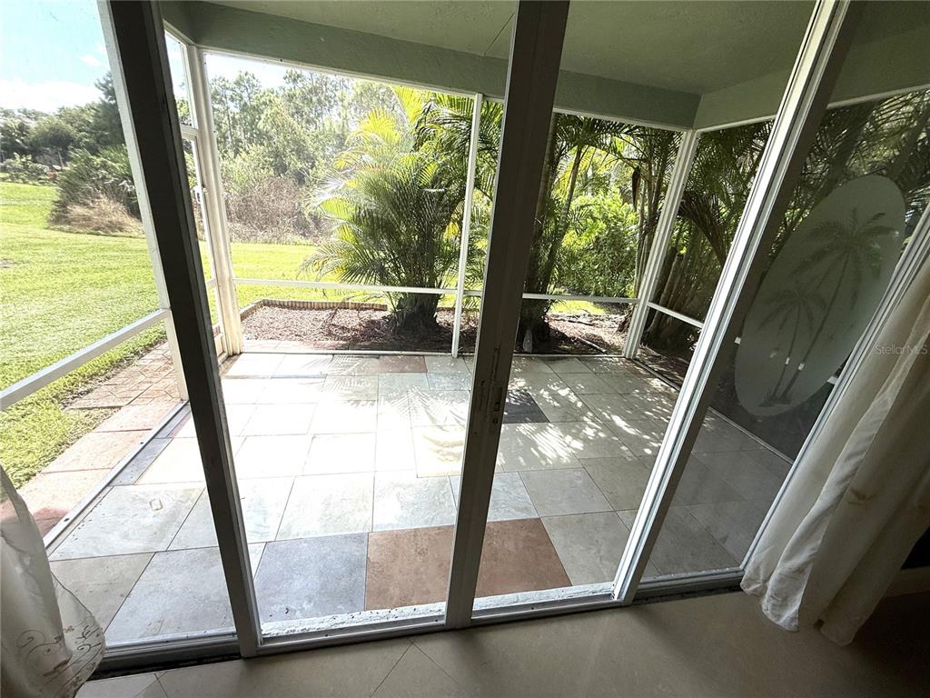 3865 Northwest Deer Oak Drive Jensen Beach, FL 34957 - Photo 31 of 34 a view of an empty room with a floor to ceiling window with a door