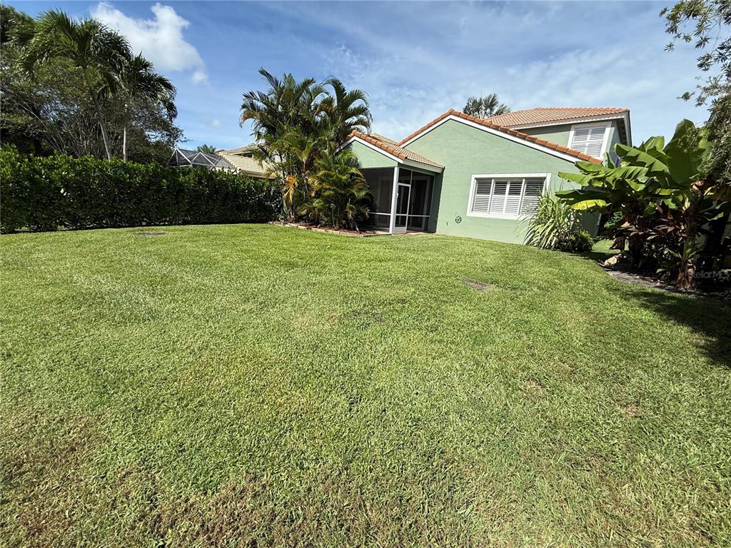 3865 Northwest Deer Oak Drive Jensen Beach, FL 34957 - Photo 34 of 34 a front view of a house with garden