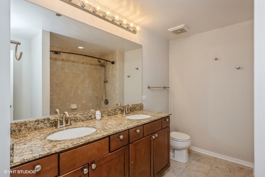 520 South State Street, Unit 702 Chicago, IL 60605 - Photo 13 of 20 a bathroom with a granite countertop sink toilet and shower