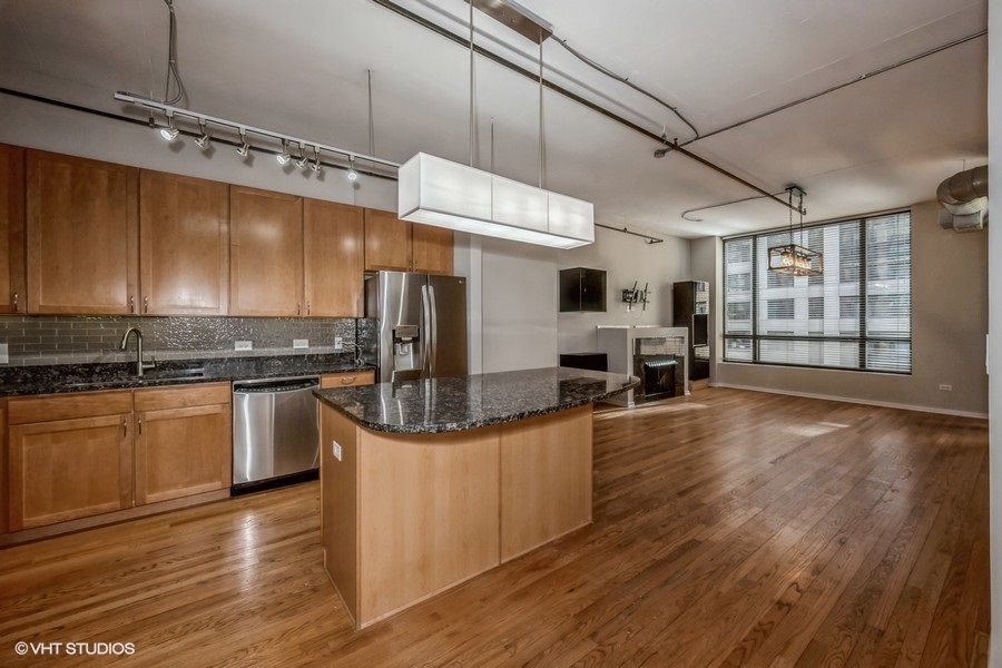 520 South State Street, Unit 702 Chicago, IL 60605 - Photo 3 of 20 a kitchen with stainless steel appliances granite countertop a stove and a wooden floors
