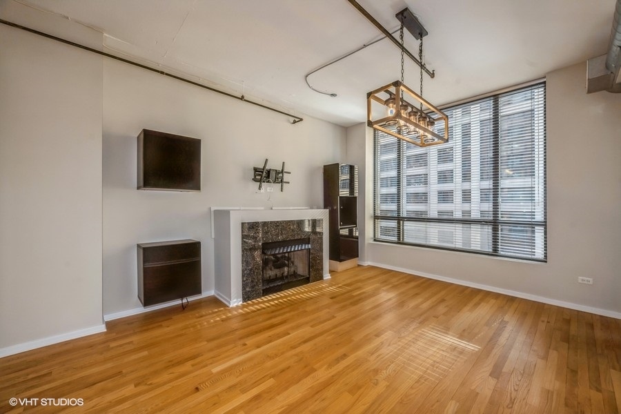 520 South State Street, Unit 702 Chicago, IL 60605 - Photo 6 of 20 a view of empty room with fireplace and windows