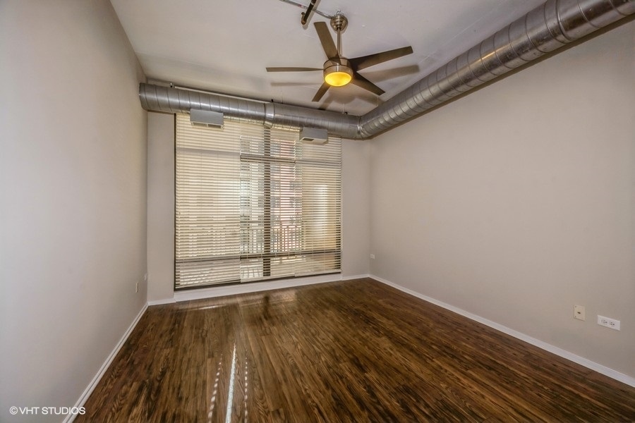 520 South State Street, Unit 702 Chicago, IL 60605 - Photo 9 of 20 a view of an empty room with wooden floor and a window
