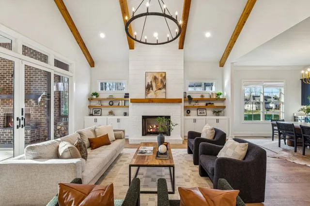 a kitchen with stainless steel appliances a sink a stove a refrigerator a center island and a cabinets