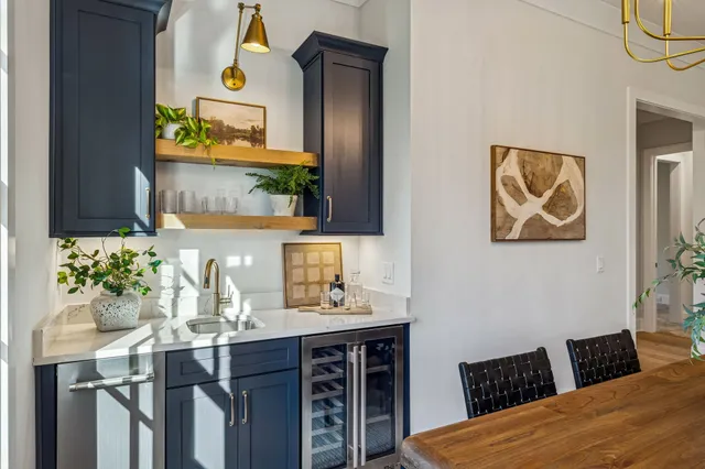 a view of a kitchen with white cabinets and a window