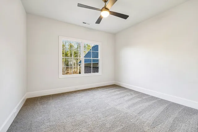 a front view of a house with yard and green space