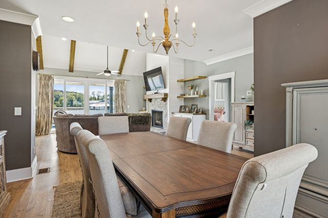 a large kitchen with stainless steel appliances granite countertop a stove a dining table and chairs