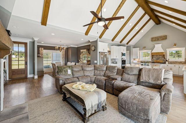a large white kitchen with a stove and a sink