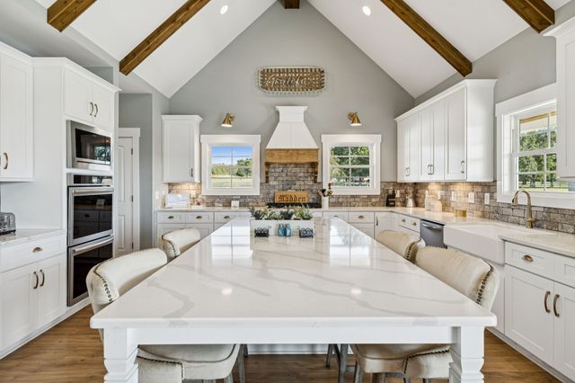 a kitchen with a sink cabinets and window