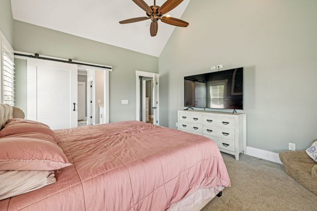 a bedroom with a bed and flat screen tv