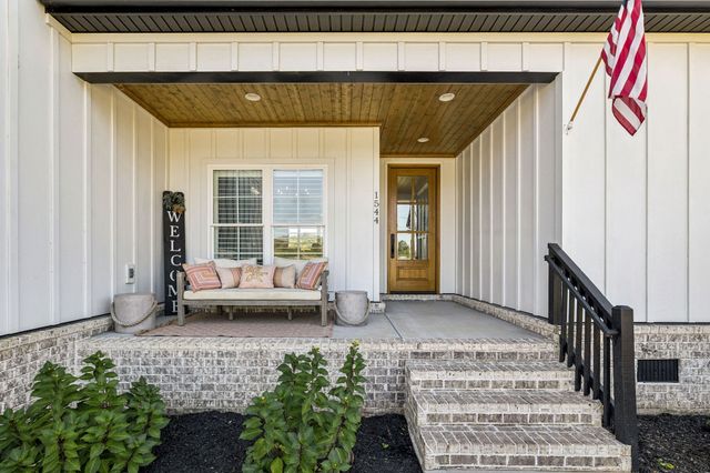 a view of a white house with a yard