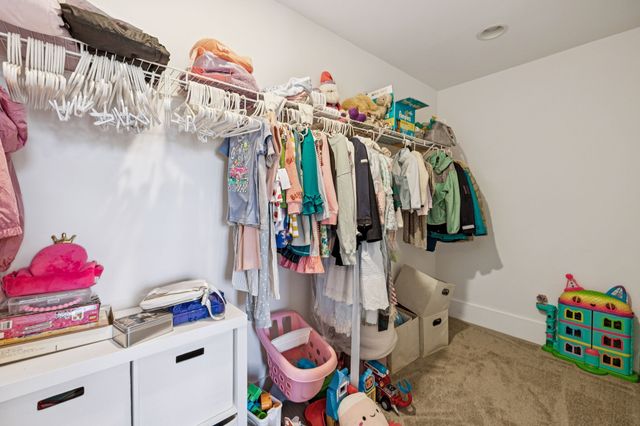 a view of walk in closet with clothes
