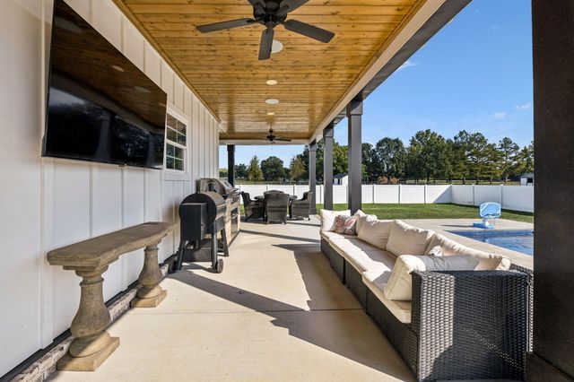 a swimming pool with outdoor seating and yard