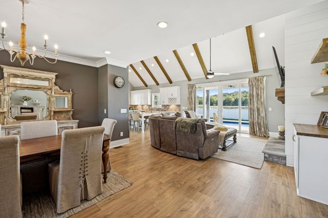 a living room with furniture and a dining table
