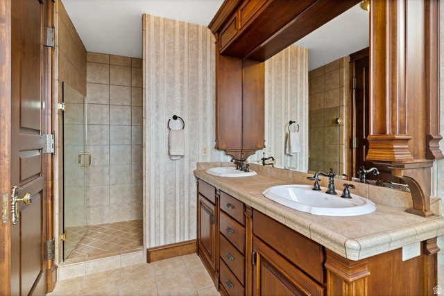 5615 East Eight Mile Gap Road Kanab, UT 84741 - Photo 42 of 81 Bathroom featuring double vanity, a shower stall, and light tile patterned floors