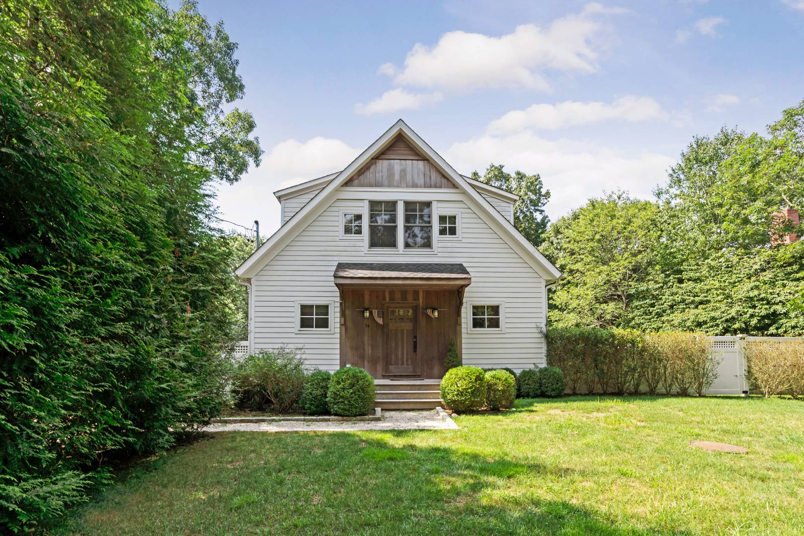 34 Towhee Trail East Hampton, NY 11937 - Photo 1 of 26 a front view of a house with yard and green space