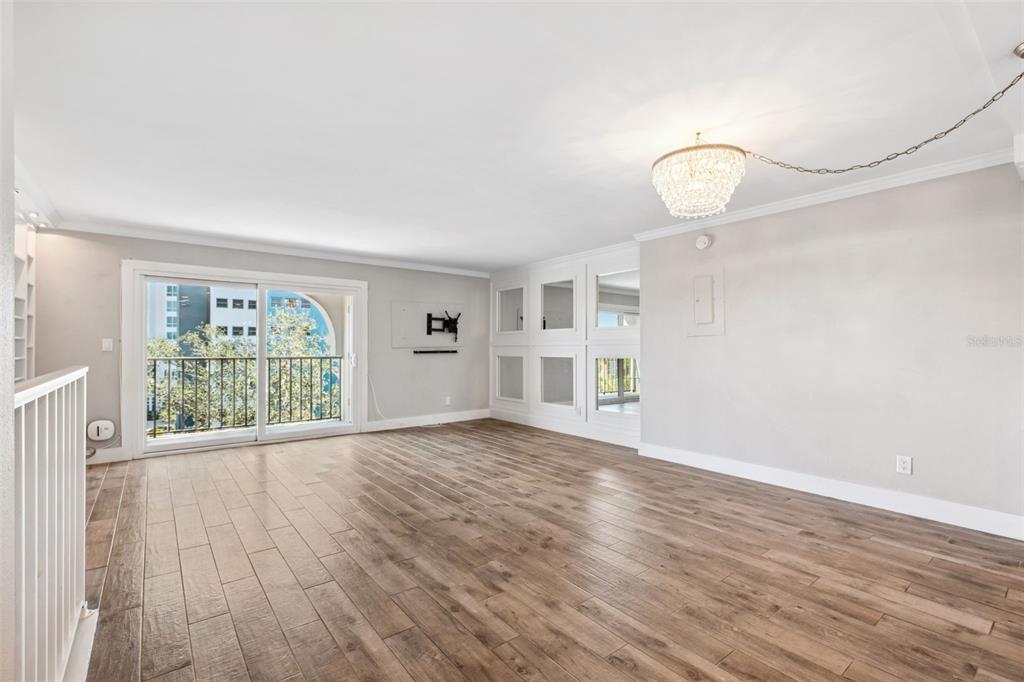 105 4th Avenue Northeast, Unit 418 St. Petersburg, FL 33701 - Photo 12 of 42 an empty room with wooden floor and windows