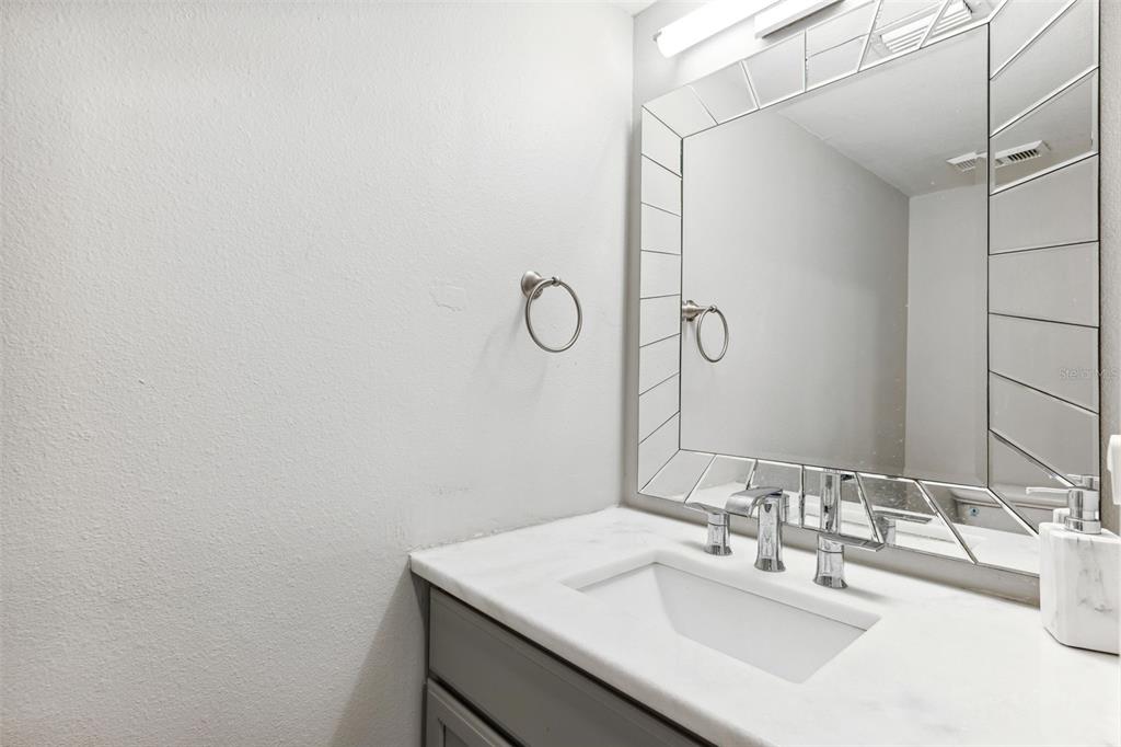 105 4th Avenue Northeast, Unit 418 St. Petersburg, FL 33701 - Photo 15 of 42 a bathroom with a sink and a mirror