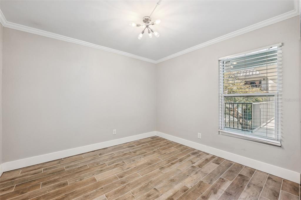 105 4th Avenue Northeast, Unit 418 St. Petersburg, FL 33701 - Photo 22 of 42 wooden floor in an empty room with a window