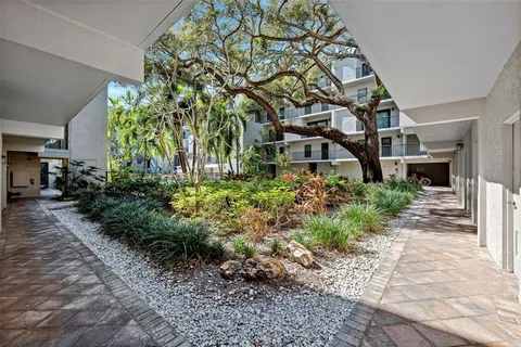 a view of swimming pool with outdoor seating and plants