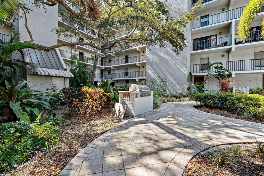 105 4th Avenue Northeast, Unit 418 St. Petersburg, FL 33701 - Photo 31 of 42 a view of a patio with table and chairs and potted plants